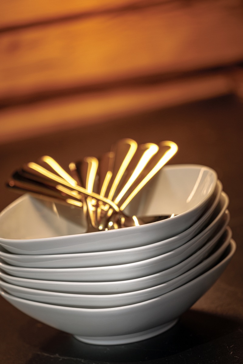 Bowls and golden cutlery ready for the table