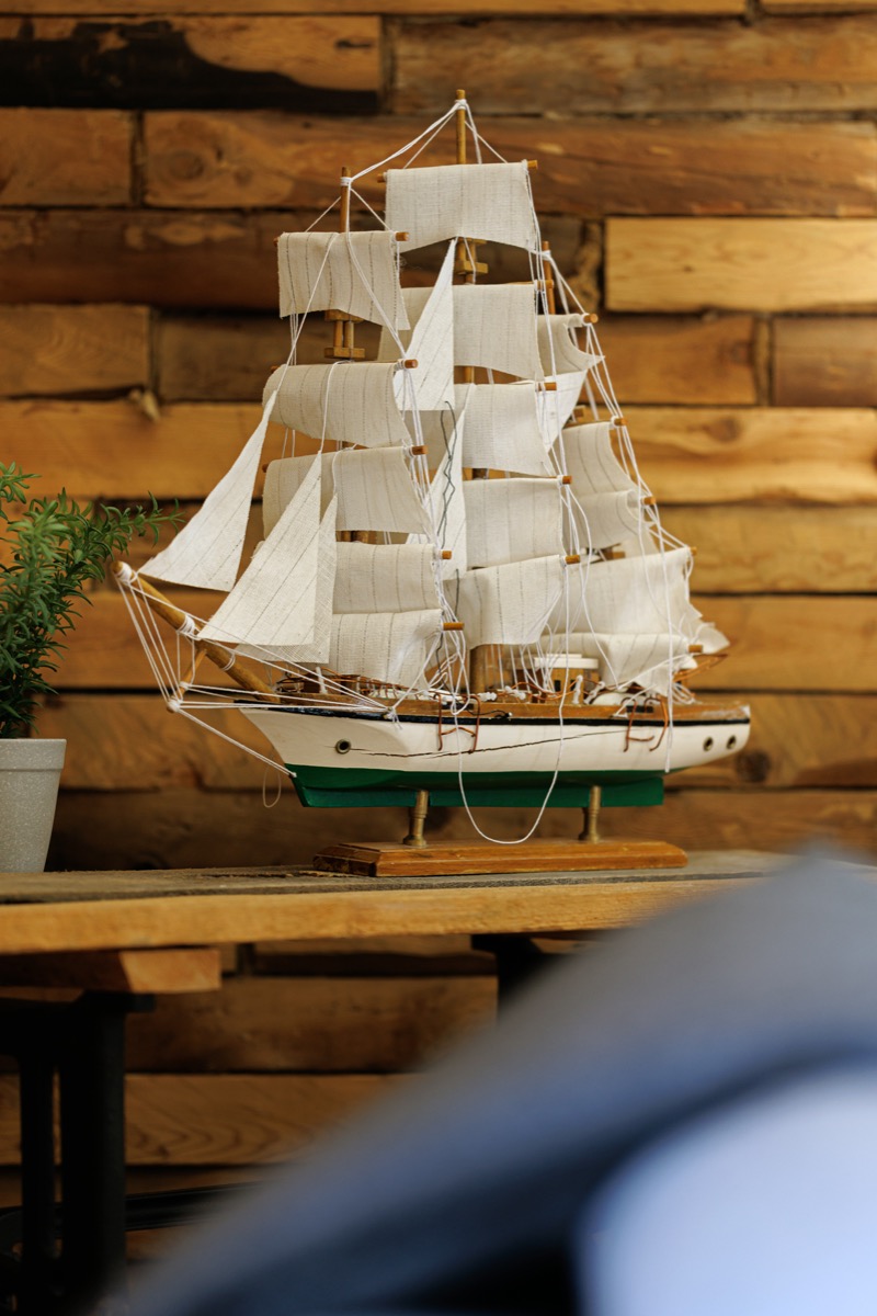 A sailing ship model against the log wall