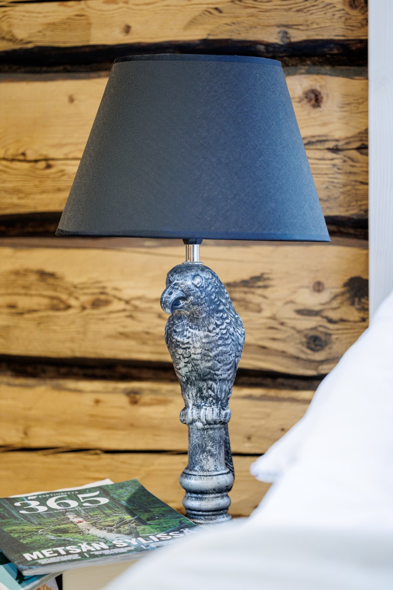A table lamp by the log wall