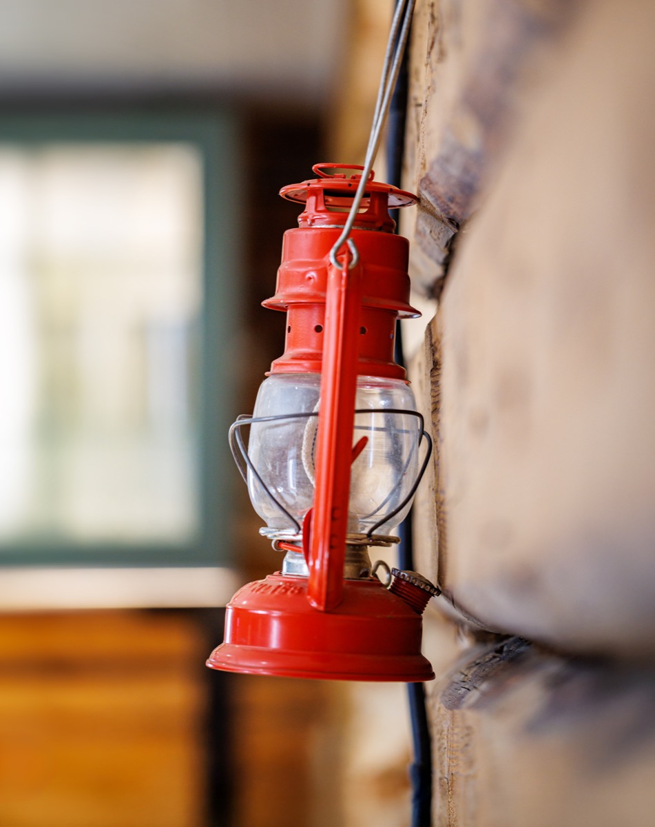 A red storm lantern on the log wall